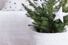 08 a minimalist Christmas tree with white ornaments in a woven basket is a cool idea for small spaces that can’t accomodate a larger tree