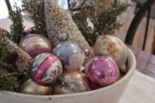 10 a bowl with vintage glass ornaments plus evergreens is a charming vintage centerpiece or just a decoration