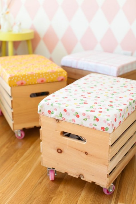 Knagglig boxes placed on pink casters and with colorful upholstered seats are perfect stools or ottomans