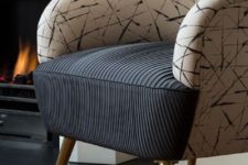 13 a chic chair with a rounded back with an abstract print and a black draped seat plus gilded legs looks modern and very chic