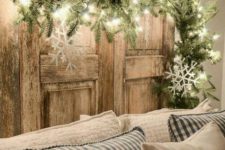 13 a lit up evergreen garland with large snowflakes over the sofa is a great way to accent your sitting space