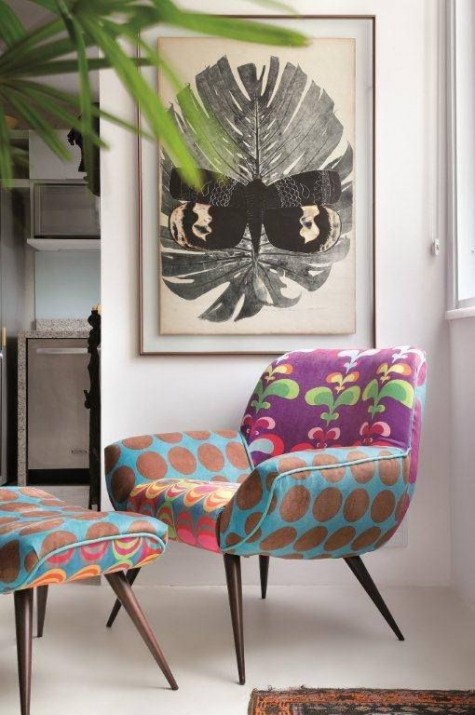 a colorful mid-century modern chair with mismatching armrests, a seat and a back plus a matching footrest for a bright spot in your home