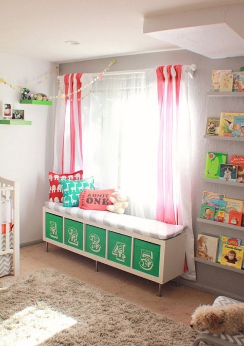 a colorful upholstered bench with numbered Drona boxes is a nice DIY for a nursery that features storage