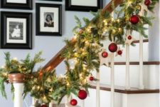 14 a lit up garland with red ornaments for banister decor is a very pretty and very stylsh idea for holidays