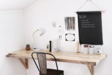 15 a farmhouse style floating desk in the corner with a metal chair and a chalkboard for making notes make up a cozy nook for work
