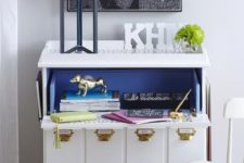 16 a Tarva hack into a little bureau and home office with blue inside and gold handles plus tags