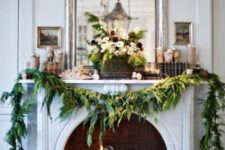 16 an evergreen garland to decorate the fireplace and make it look very Christmassy