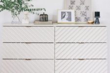 18 a trendy Tarva dresser hack with striped wall panels, light-colored stained legs and a frame and brass pulls