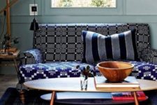 20 a bold sofa with a windowpane printed back and armrests and a geometric print seat fits this moody interior making it brighter