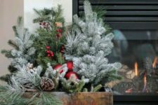 20 a crate arrangement with evergreens, red ornaments, pinecones is a cozy and fresh decor idea  for holidays