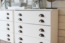 22 a white IKEA Tarva hack with sleek panels and vintage handles looks chic and will fit a farmhouse space