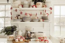 22 retro farmhouse Christmas kitchen styling with Santa mugs, mini mitten garland and evergreen arrangements