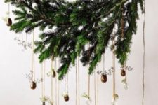 23 an evergreen branch with small vases and greenery in them is a stylish overhead Christmas decoration