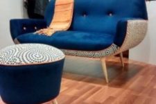 24 a mid-century modern loveseat with a navy top and a printed base and a matching footrest or ottoman