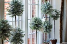 24 cool evergreen Christmas topiaries in pots are an unexpected and non-traditional decoration for the holidays