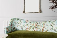 25 a refined mismatched upholstery sofa with a velvet green seat and a botanical and fauna print in blue on the back