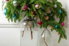 25 evergreen branches with colorful Christmas ornaments placed into jars are bold holiday decorations and centerpieces