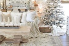 a fantastic farmhouse Christmas space with a snowy tree, doily snowflakes, signs with lights and fun deer figurines
