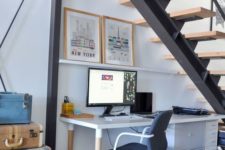 a small contemporary under the stairs home office with a desk with storage, a ledge and vintage suitcases for storage