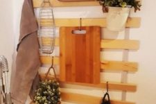 an IKEA Luroy slatted bed base turned into a cool kitchen item with hooks and hangers