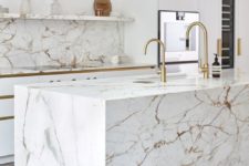 02 a chic white kitchen done with strongly veined marble – on the backsplash, countertops and kitchen island