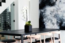 03 a chic contemporary dining room with a black table and a fantastic watercolor artwork on the wall