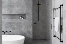 08 a minimalist bathing space done with grey marble tiles and matte black fixtures for a chic look