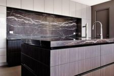 08 a moody kitchen with black veined marble that covers the backsplash and countertops for eye-catchiness