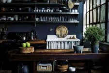 10 a vintage navy kitchen with metal shelving, a wooden kitchen island and elegant and chic decor