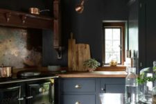 13 a moody navy kitchen with wooden countertops and beams, a vintage hearth and some chic copper touches