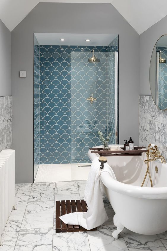 blue scallop tiles accent the shower space and make it stand out with their color and shapes