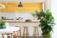 17 a welcoming kitchen with sleek and shiny sunny yellow upper cabinets for a bright touch