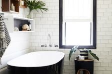 18 a chic modern black and white bathtub matches the patterned tiles on the wall