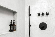 22 a neutral shower space with a matte black bathroom fixtures looks bold and contrasting