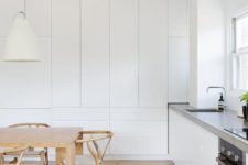24 an ultra-minimalist white kitchen with built-in furniture with no handles and concrete countertops