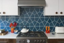 25 a trendy two tone kitchen with a deep blue geometric tile backsplash that makes it wow