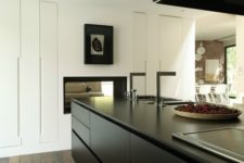 26 a minimalist black and white kitchen with no handles, artorks, built-in lights looks very chic