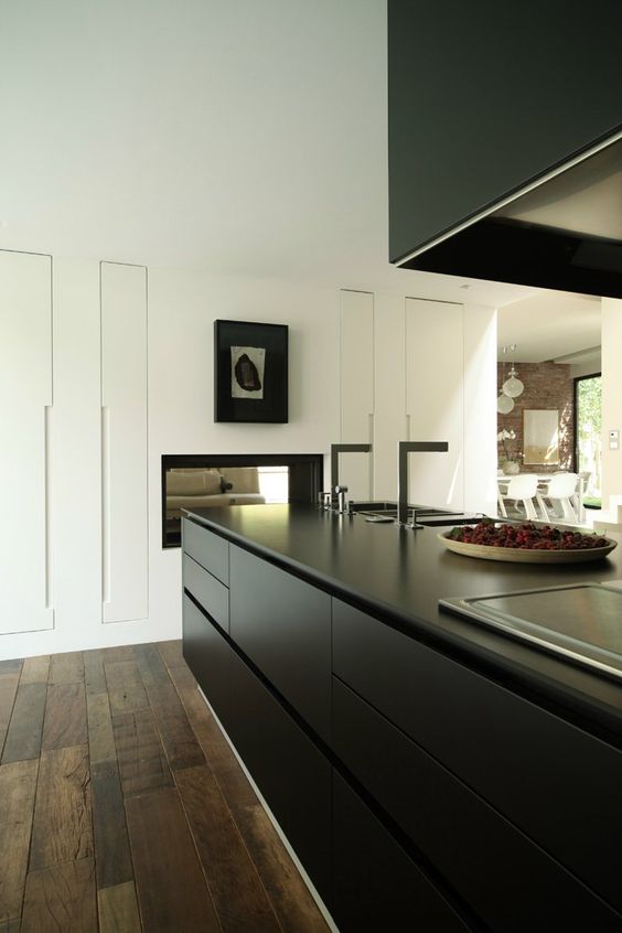 a minimalist black and white kitchen with no handles, artorks, built-in lights looks very chic