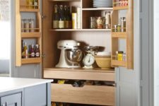 27 a large kitchen larger cupboard with natural wooden drawers and shelves for storage
