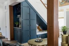 a blue storage unit with open and closed compartments and drawers is a cool color accent in the space