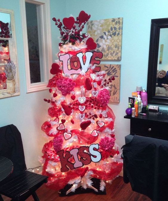 a bright hot pink Valentine tree with lights, fabric blooms, hearts, LOVE letters and hot pink ribbons