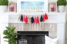 a colorful tassel garland, bright blooms in lanterns and LOVE letter plus a dreamy artwork