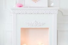 a cute Valentine fireplace with candles, an artwork with a paper heart, candles and white petals in the mid-air