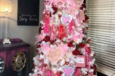 a fancy Valentine tree with pink and red heart ornaments, paper hearts, conversation hearts and lights