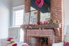 a gold heart and colorful pompom garland, a heart wreath and a heart sign