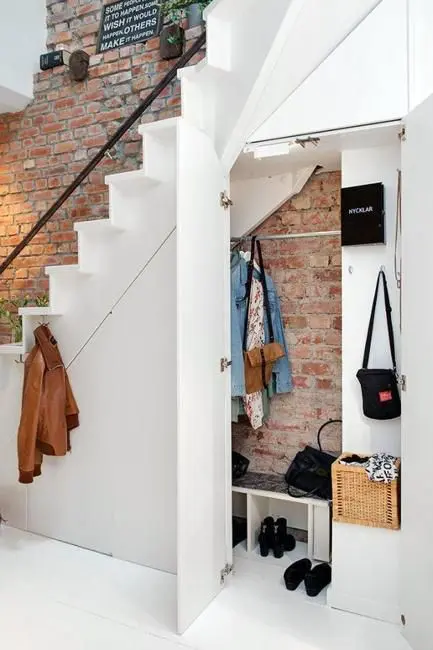 a hidden Scandinavian mudroom with a rack and shoe storage, some hooks and baskets is a super cool idea