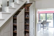 a shoe storage with large drawers and an additional cabinet built into the staircase is a lovely idea