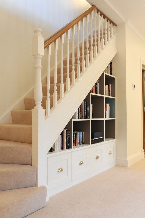 a staircase with a whole bookcase built in under it, with drawers and open shelves, is a smart solution for every space