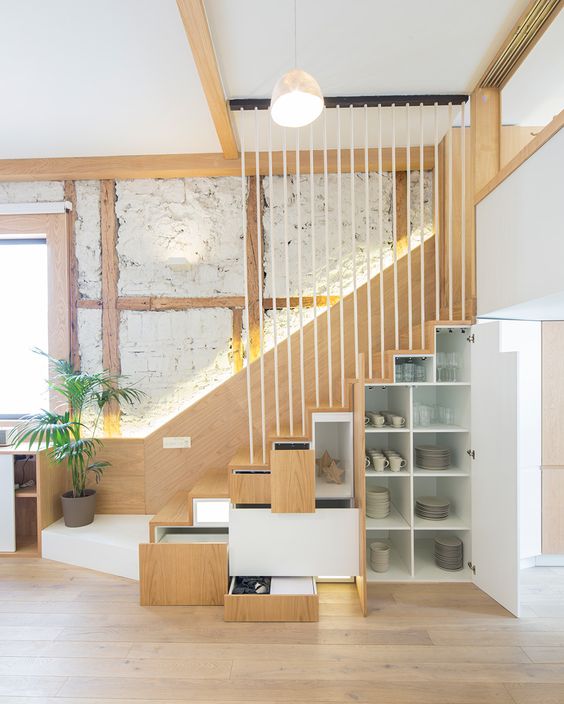 a staircase with built-in drawers and cabinets is a smart and cool idea for a modern space, it can be a nice solution