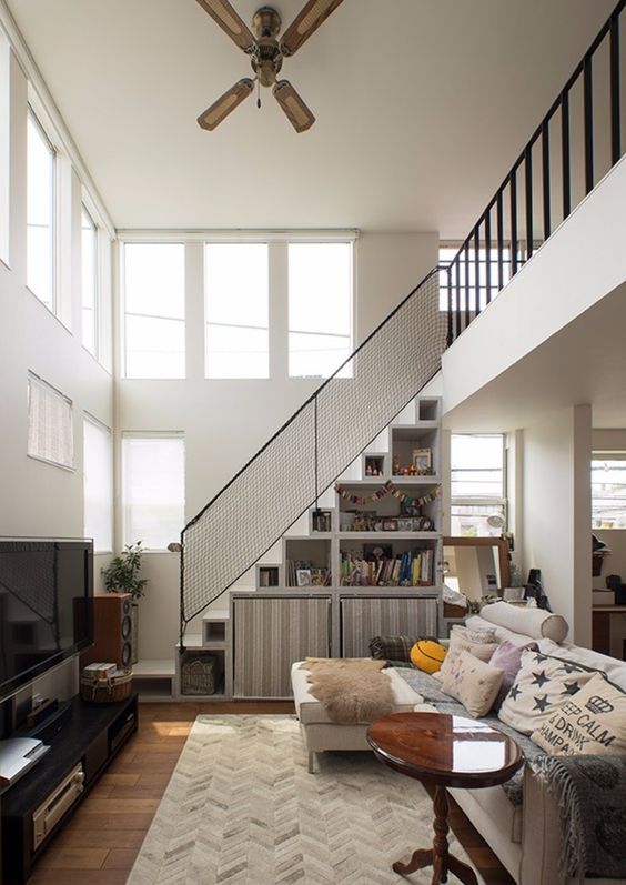 a staircase with shelves and large fabric cubbies is a smart way to store some things